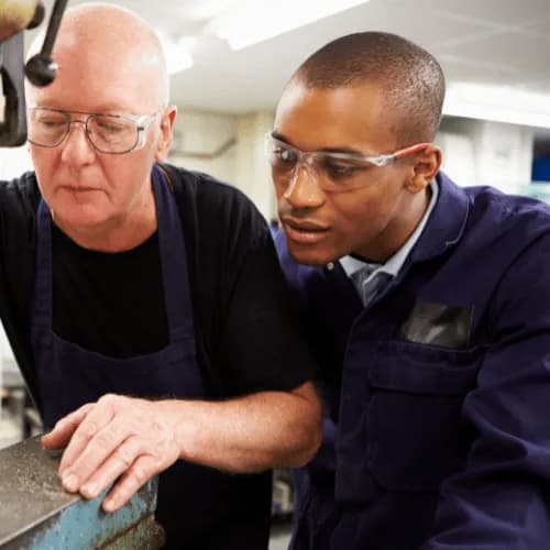 An Index specialist training a manufacturer on how to use a capsule filling machine.